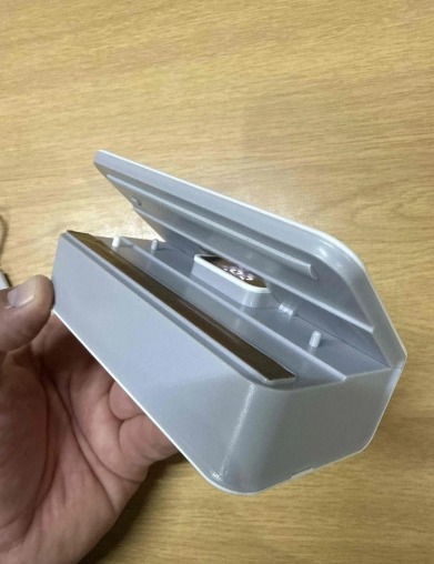 Open Sealvero bag sealer held in a hand showing the heating bar
